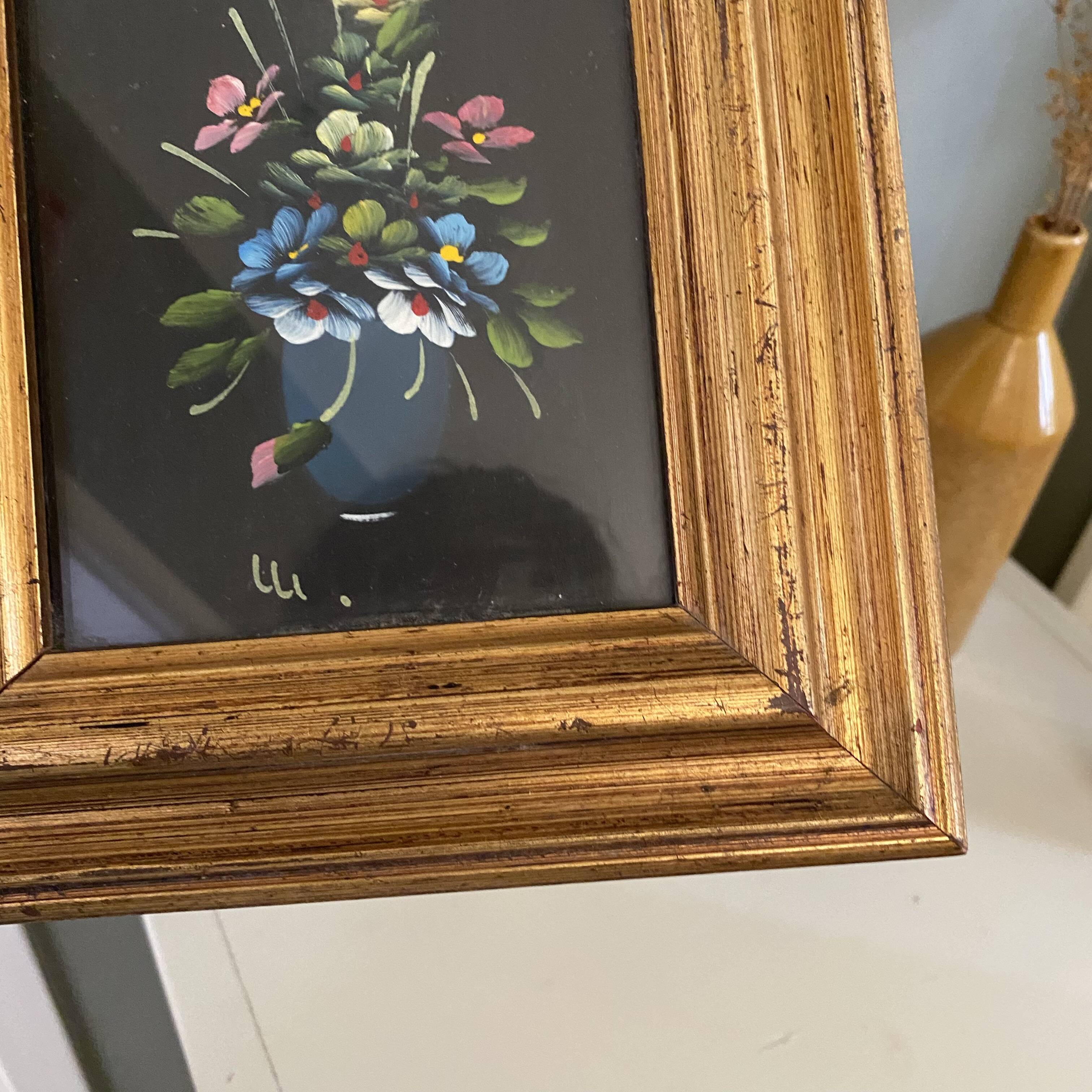 Golden frame with painting bouquet of flowers