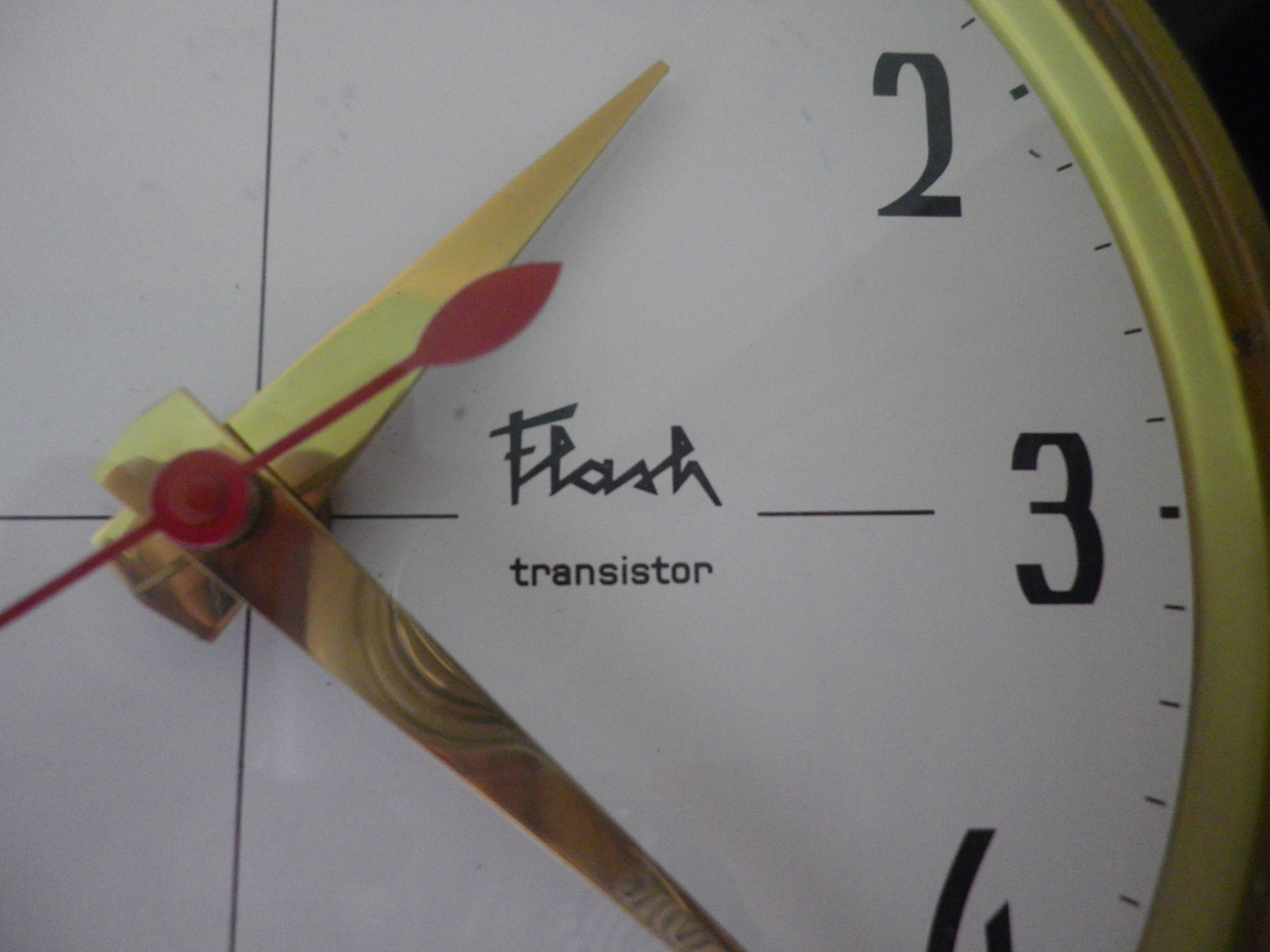 Black formica wall clock, Flash Transistor brand, Flavia model