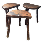 Trio of brutalist stools with tripod legs
