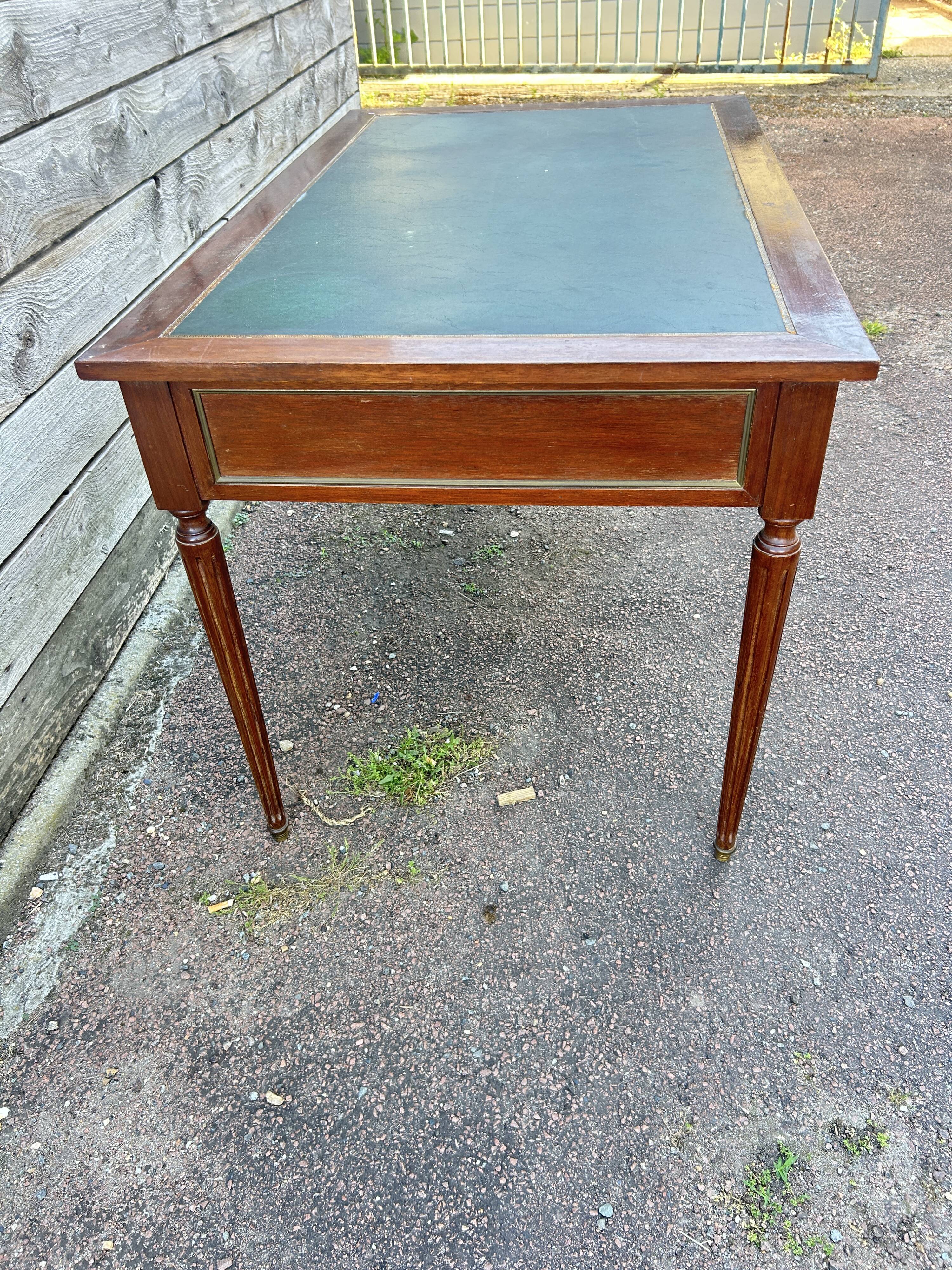 Louis XVI style desk in mahogany with a green leather top.