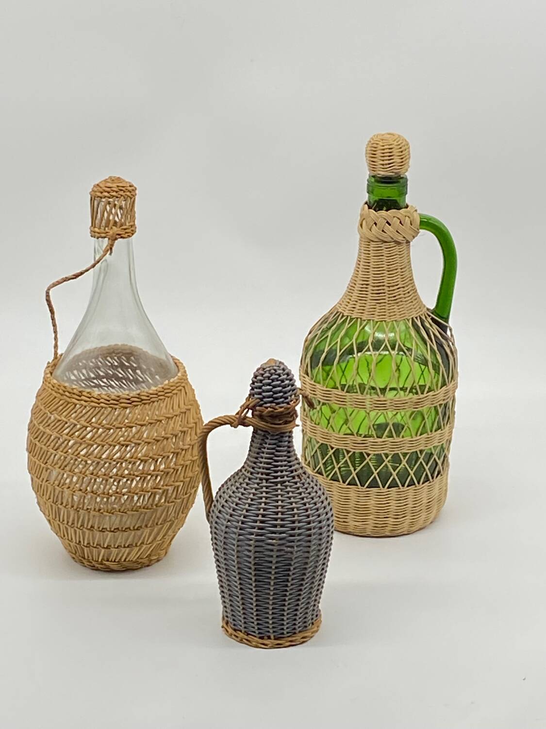 Trio bottles / lady Jeanne, dressed in wicker, rattan, natural fibers