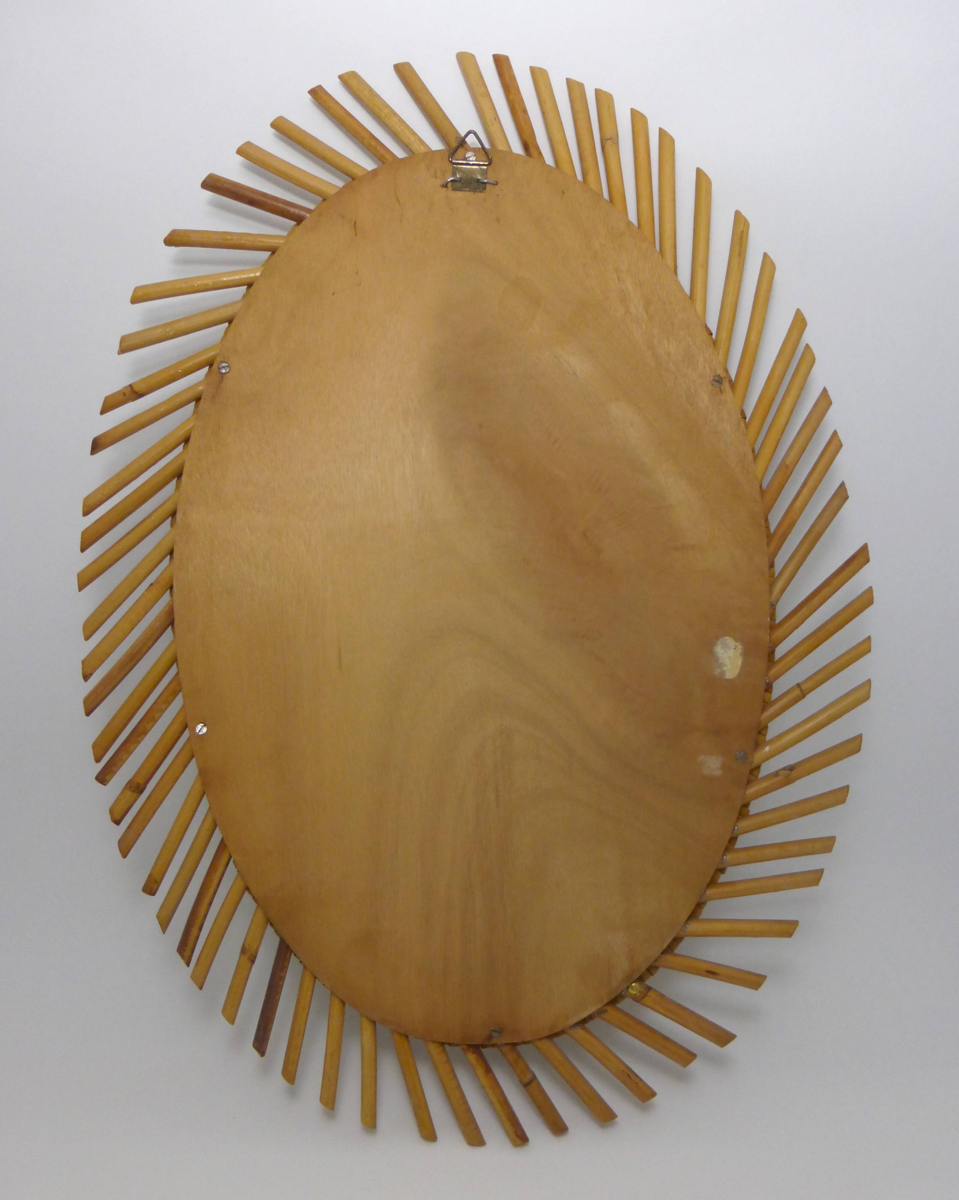 Mirror rattan oval radiating around 1960  - 37x50cm