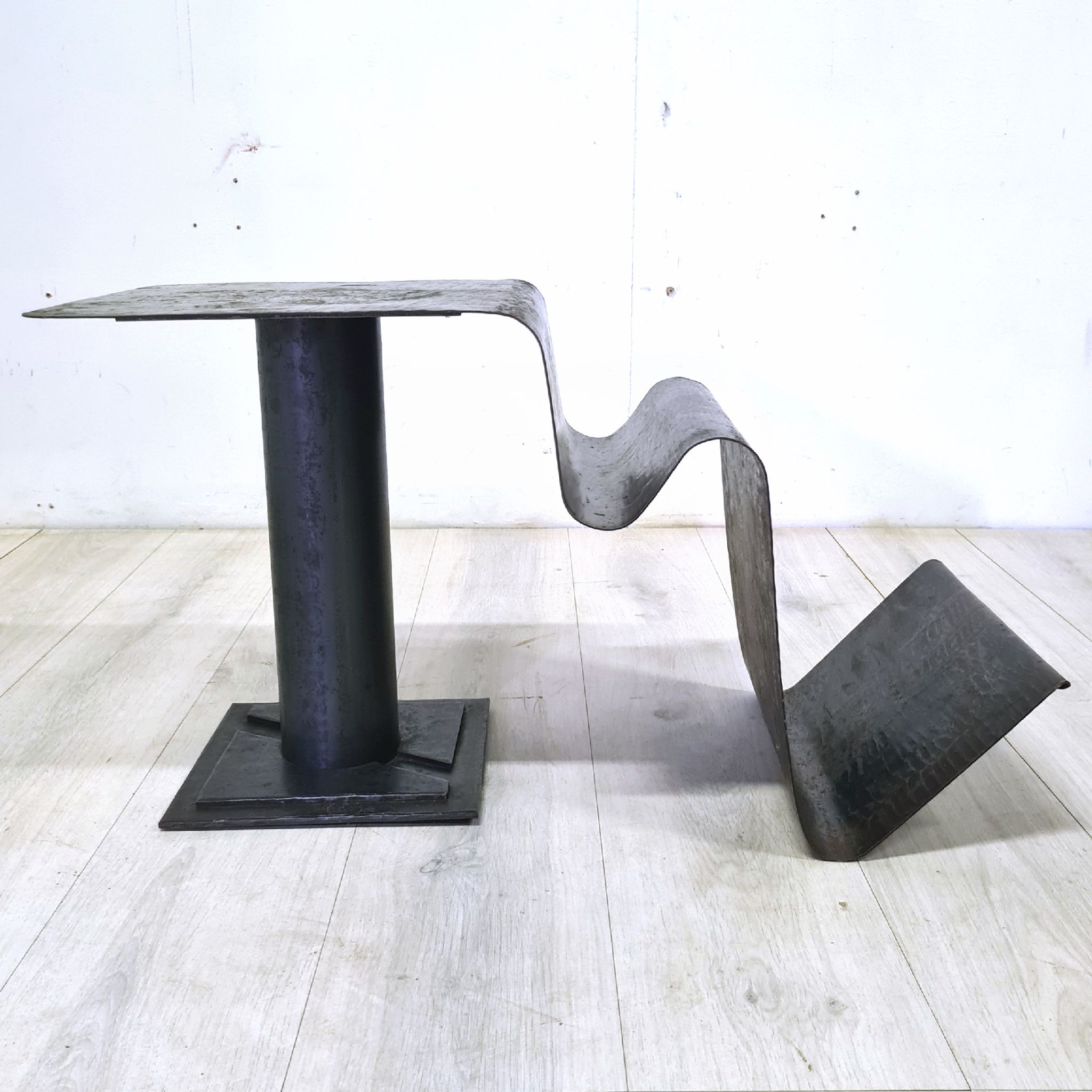 Curved sheet metal side table with magazine stand, 1980s