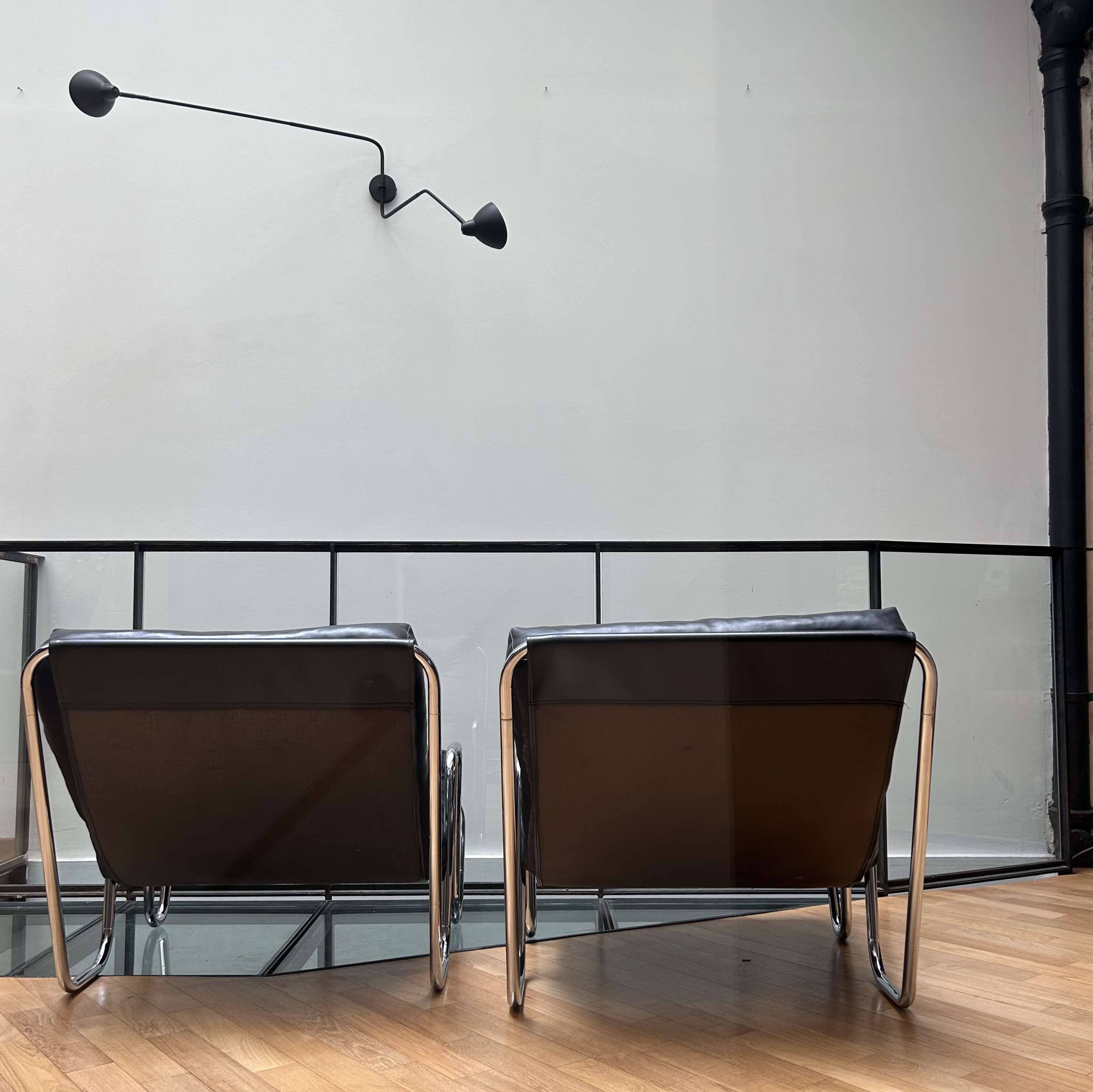Pair of vintage armchairs in black imitation leather and chrome metal, France 1970
