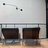 Pair of vintage armchairs in black imitation leather and chrome metal, France 1970