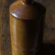Vintage Bourne Deney stoneware liqueur bottle with pouring spout.