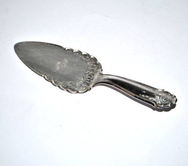 Vintage silver-plated pie server with rose decoration.