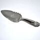 Vintage silver-plated pie server with rose decoration.
