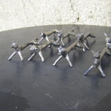 Series of eight antique knife holders in silver metal.
