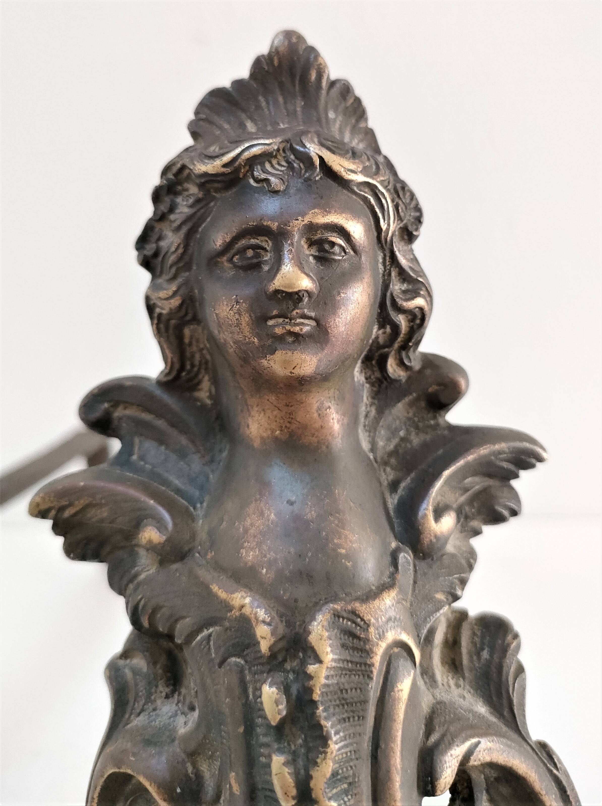 Pair of bronze andirons with black patina, 19th century, female caryatids
