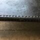 large industrial table in graphite black riveted metal
