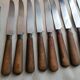 Old table knives and dessert knives, wooden handles, stainless steel blades