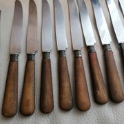 Old table knives and dessert knives, wooden handles, stainless steel blades
