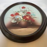 Oval painting of a bouquet of flowers, oil on panel.