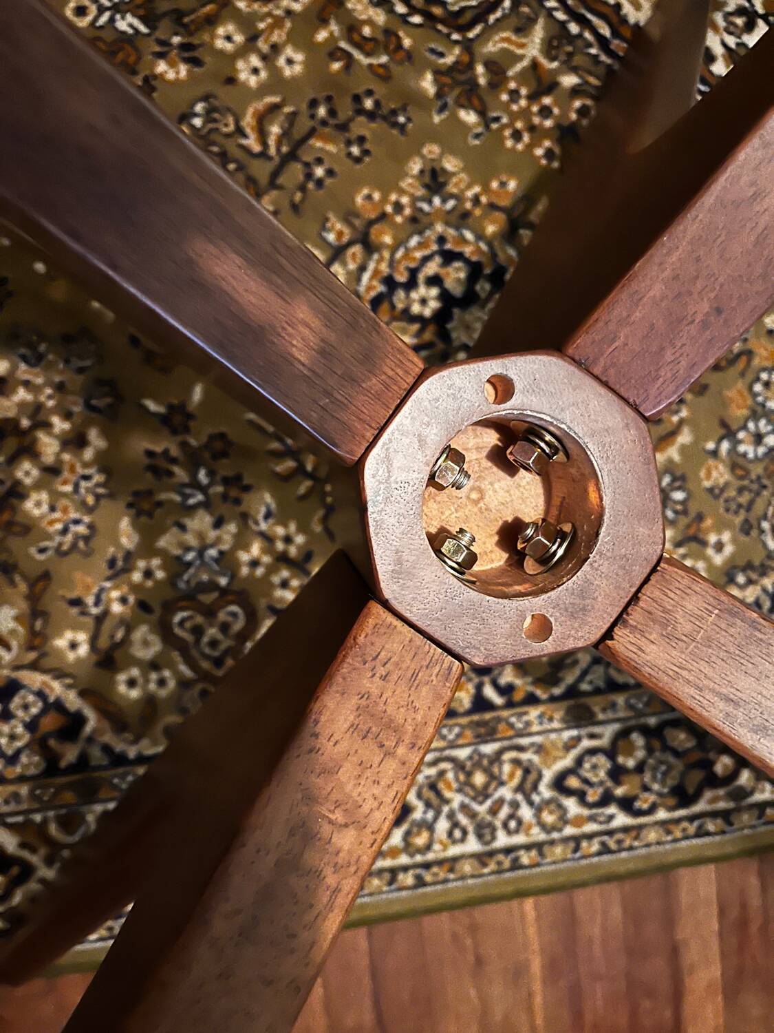 Round table made of solid wood with a walnut finish top.
