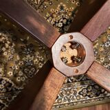 Round table made of solid wood with a walnut finish top.