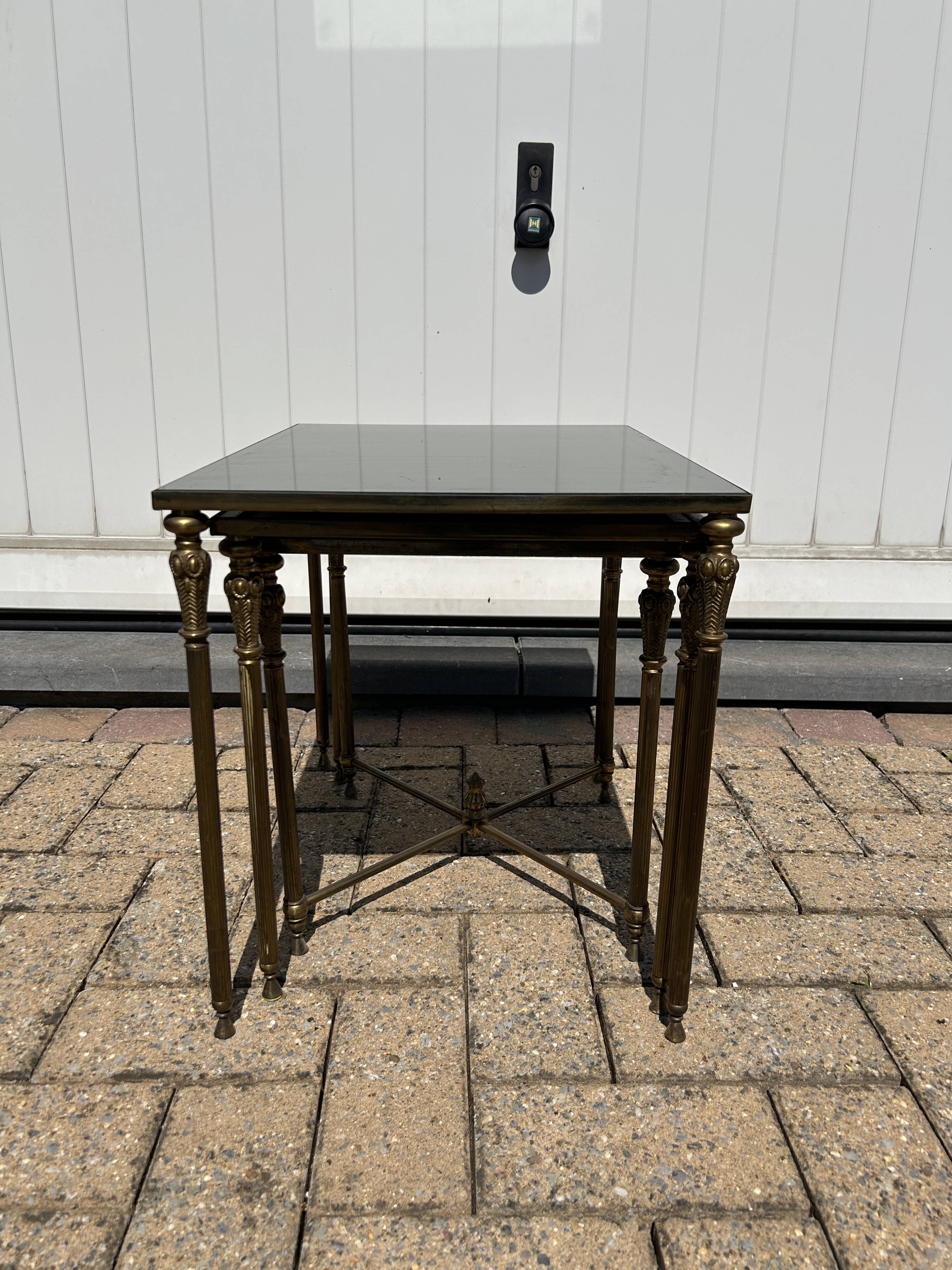 Nested tables in gilded brass in the style of Maison Charles.