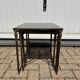 Nested tables in gilded brass in the style of Maison Charles.