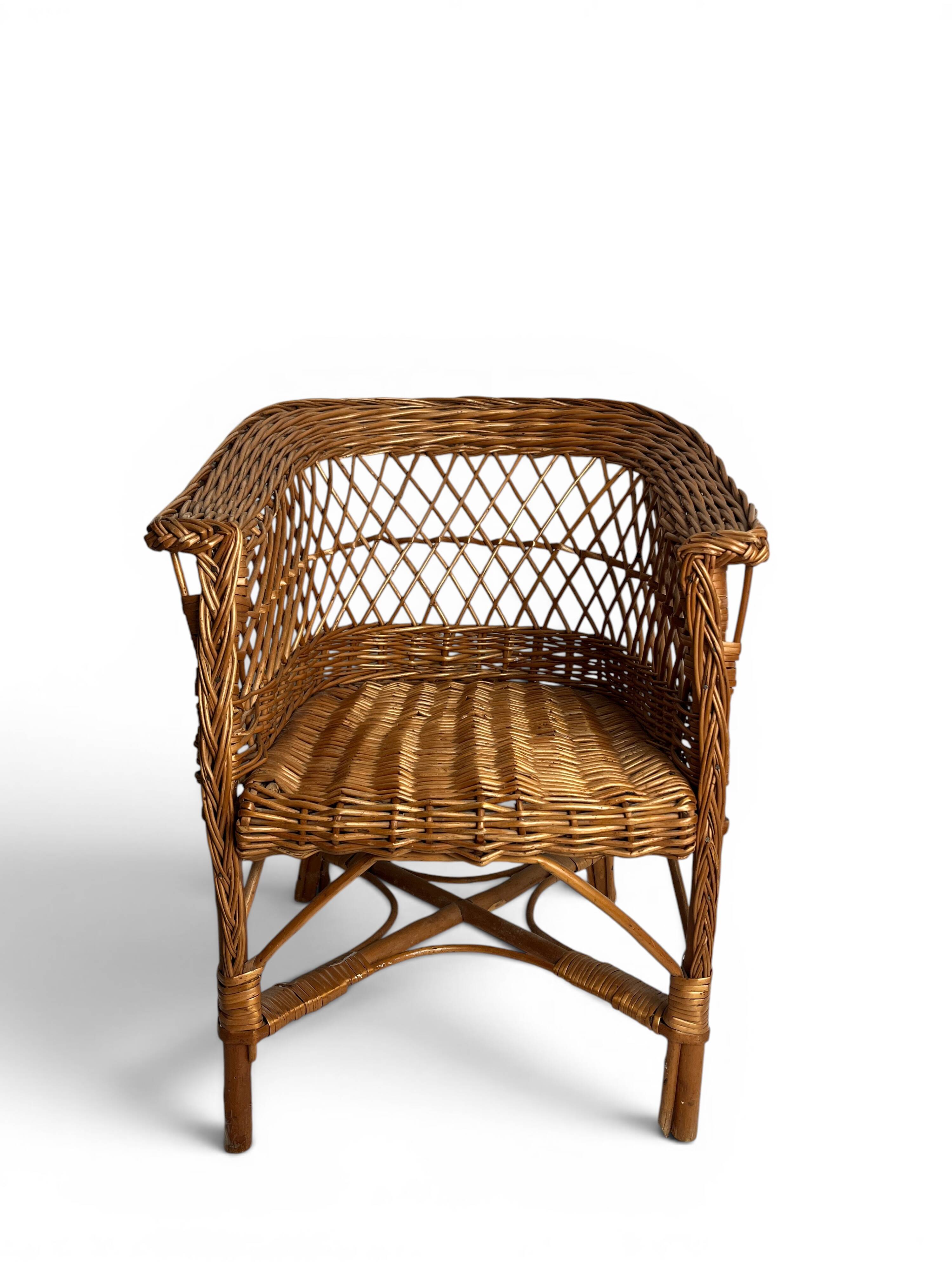 Vintage, children's armchair in woven rattan from around 1970.