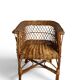 Vintage, children's armchair in woven rattan from around 1970.