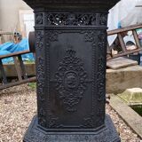 Black cast iron wood burning stove with solid brass handle.