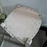 Vintage wooden stool with white peeling paint