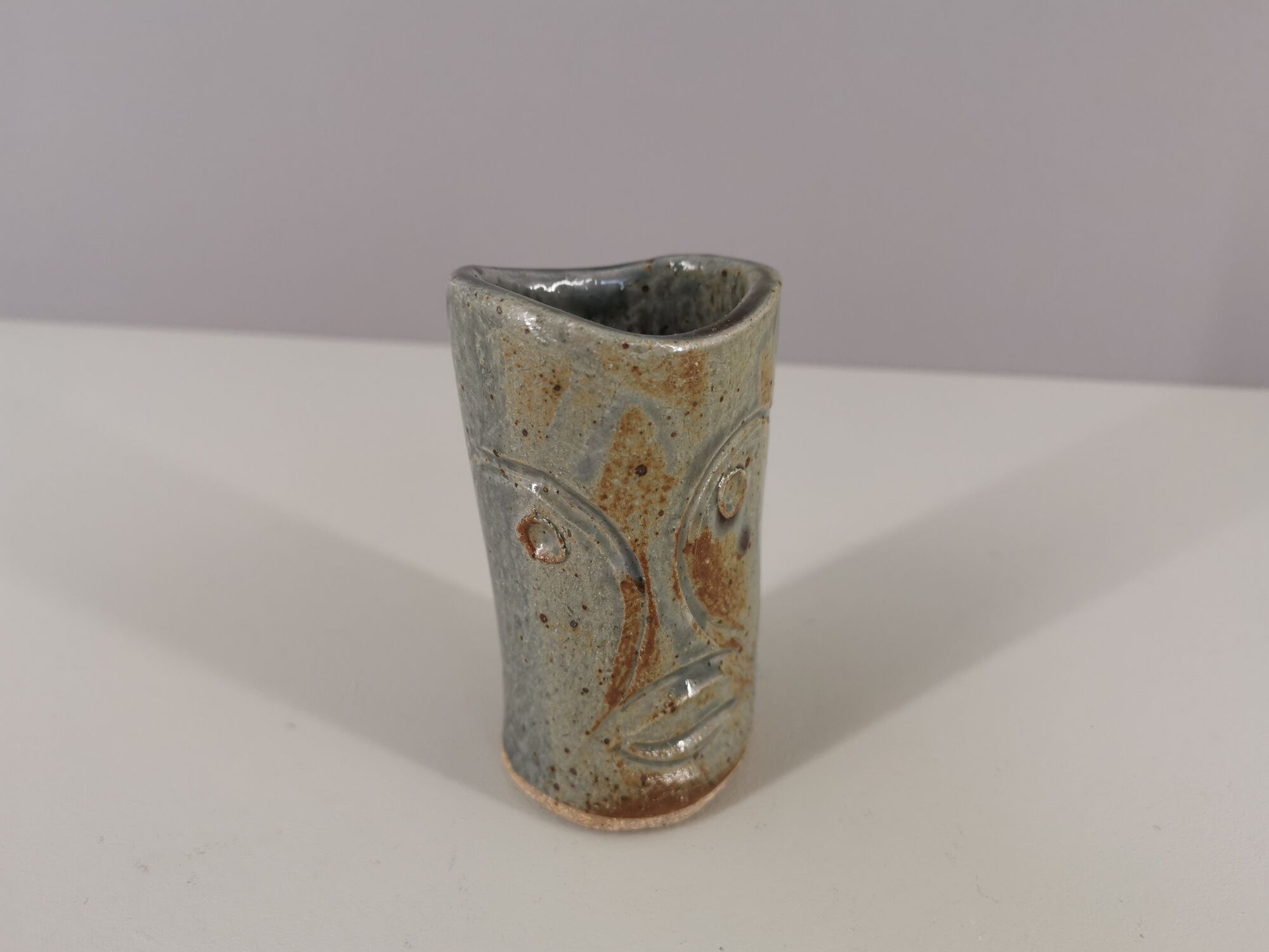 Signed vase in enamelled sandstone with stylized face
