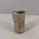 Signed vase in enamelled sandstone with stylized face