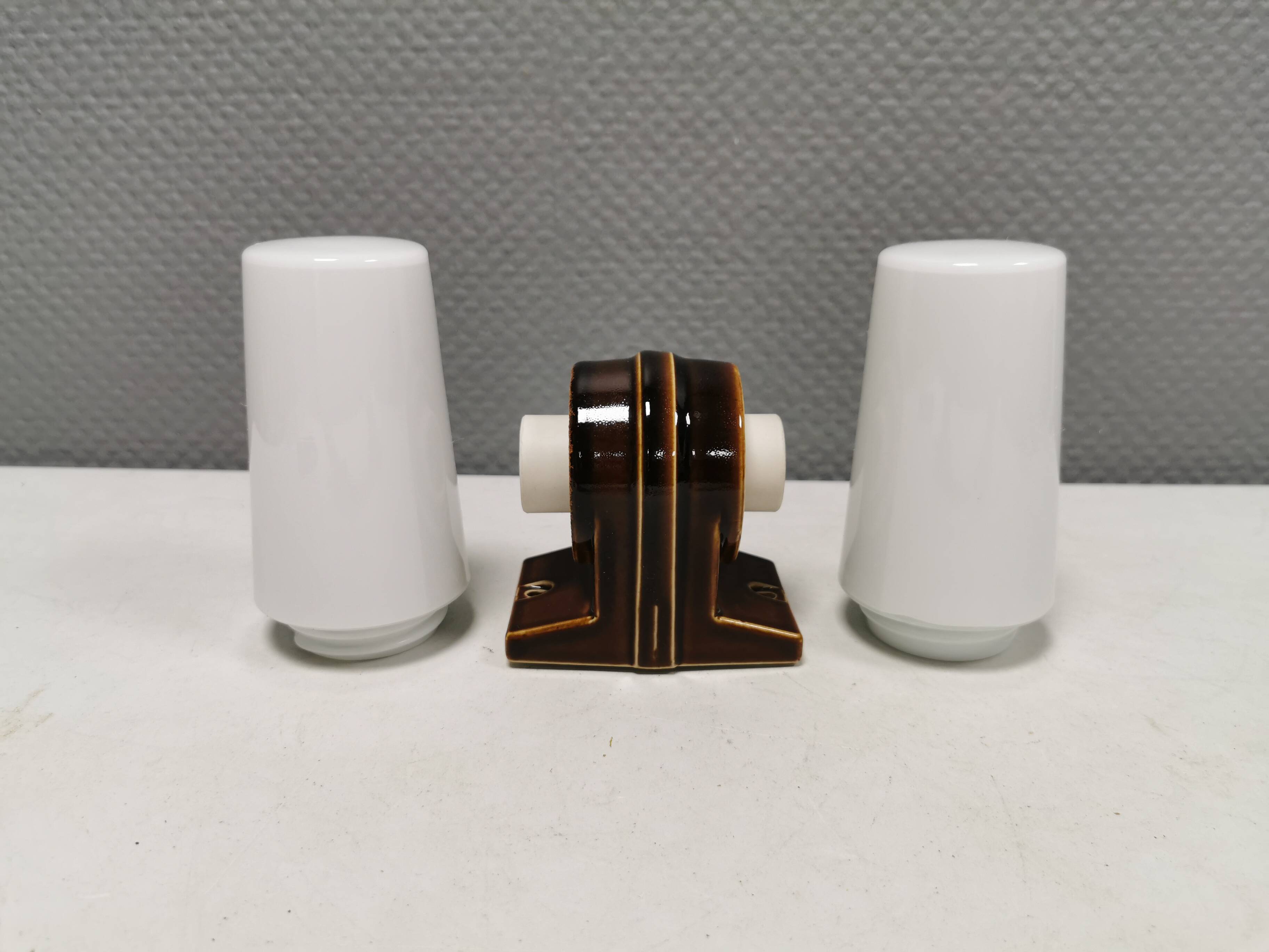 Old bathroom lamp with brown/golden ceramic base, porcelain socket and milky white glass