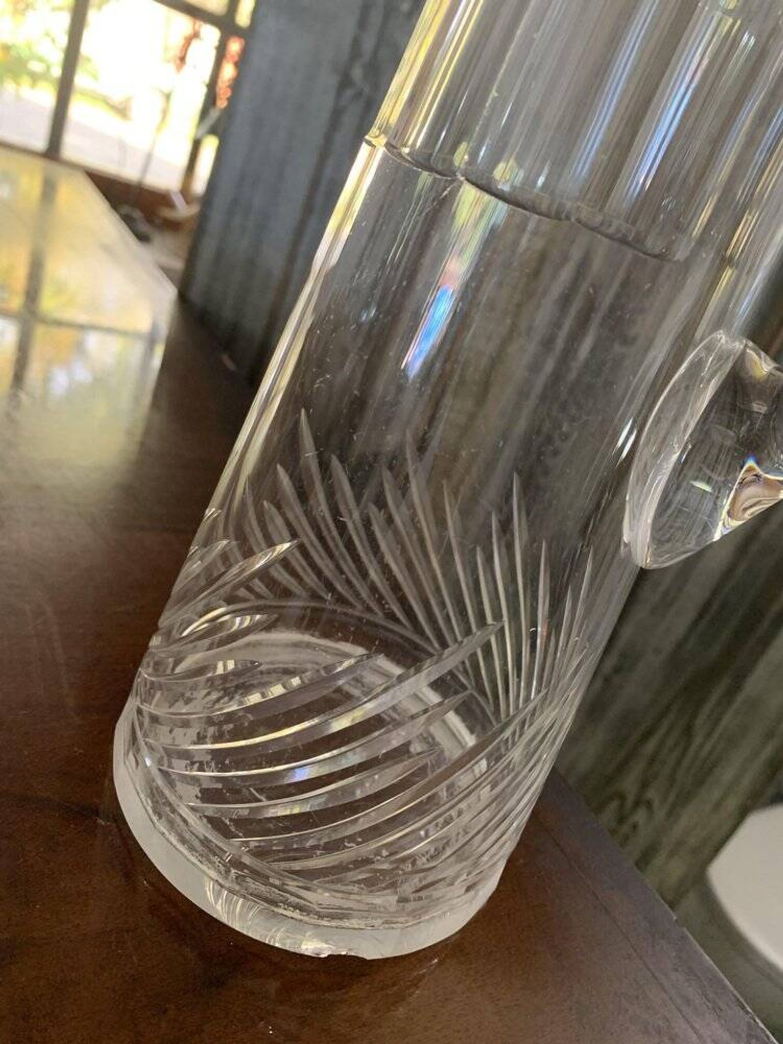 Transparent crystal pitcher, mid-century Hungarian, conical silhouette, sculptural handle and cut decoration.