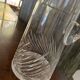 Transparent crystal pitcher, mid-century Hungarian, conical silhouette, sculptural handle and cut decoration.
