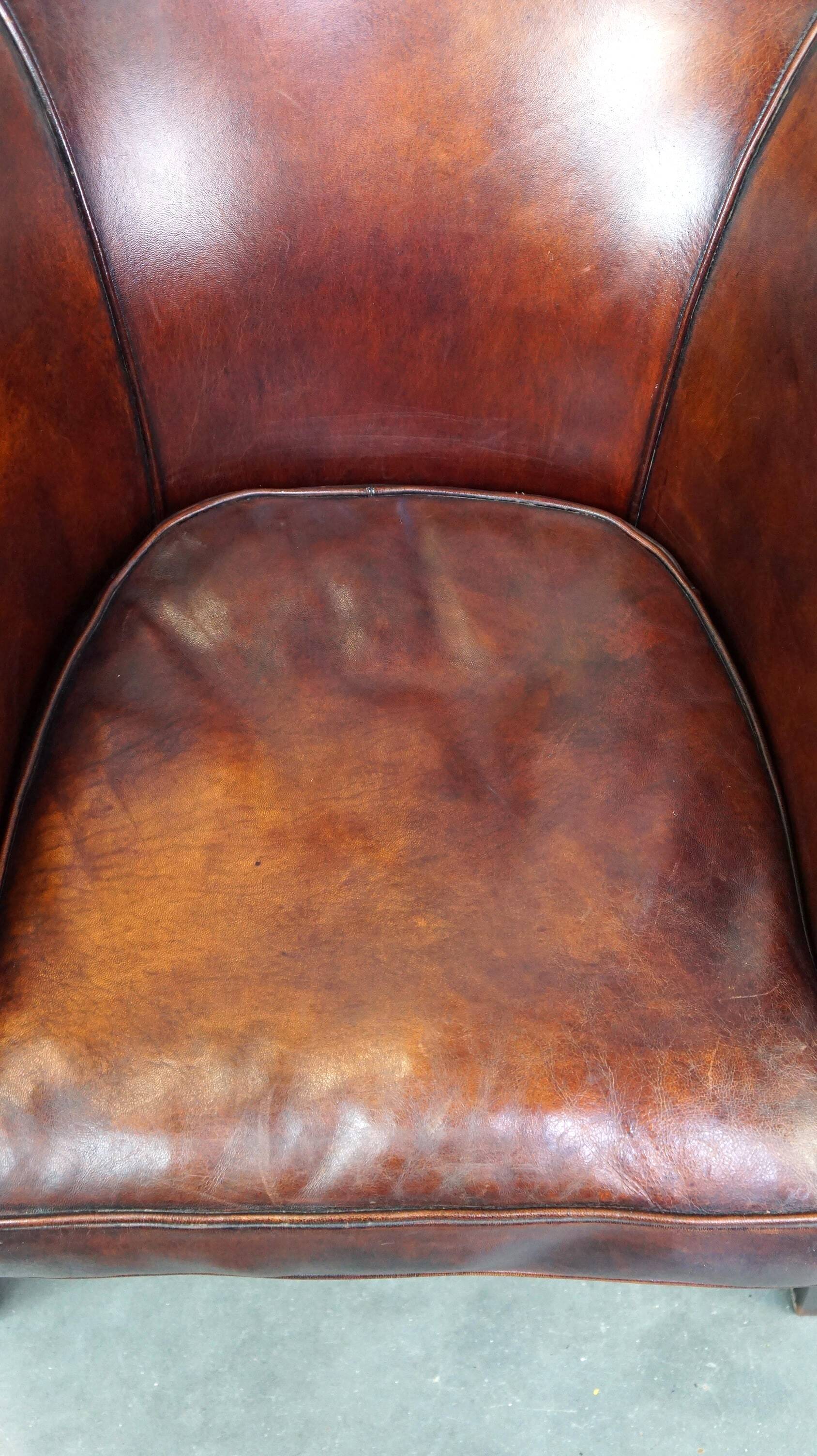 Very luxurious dark brown sheepskin club chair with a more than beautiful patina