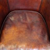 Very luxurious dark brown sheepskin club chair with a more than beautiful patina