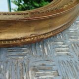 Antique oval mirror in gilded stucco with gold leaf, 19th century