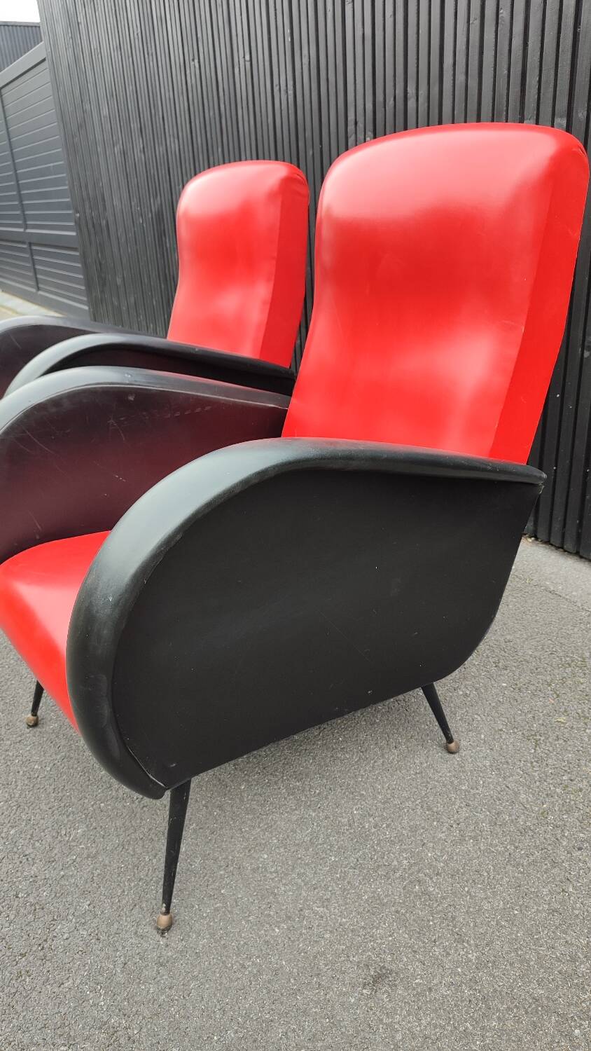 Pair of red and black faux leather armchairs