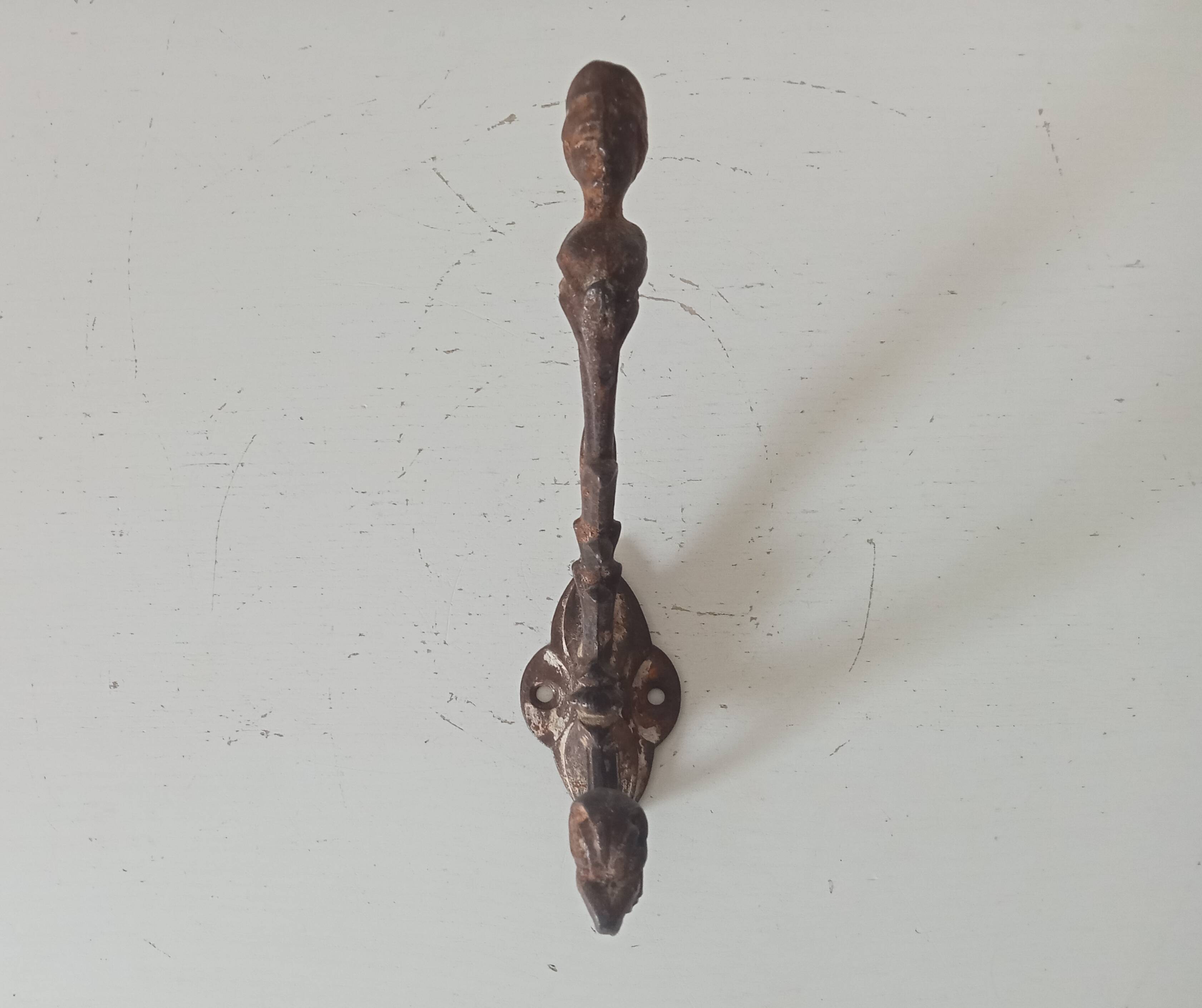 Antique wall coat hook from the 19th century in Victorian cast iron style.