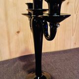 Set of four black glass candle holders.