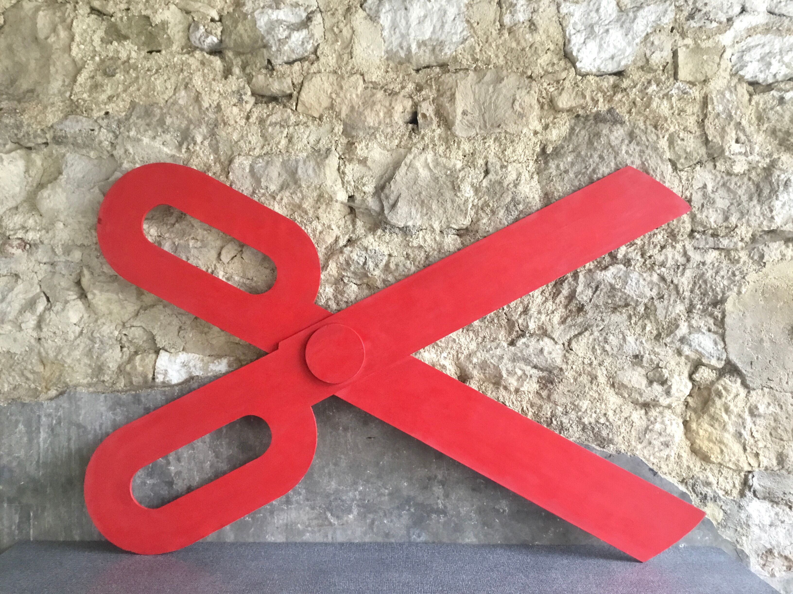 Wooden sign in the shape of scissors