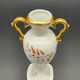 Small amphora vase in Limoges porcelain with gilded handles.