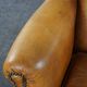 Old wingback armchair made of sheep leather in a correct condition