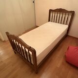 1 bed with a wooden frame and mattress