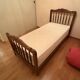 1 bed with a wooden frame and mattress