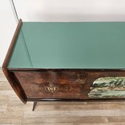 1950s mahogany sideboard with a glass top and central bar.