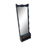 A renovated mirror in a wooden frame with a drawer and a shelf
