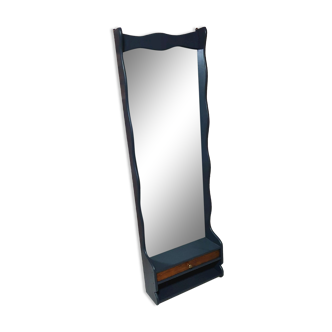 A renovated mirror in a wooden frame with a drawer and a shelf