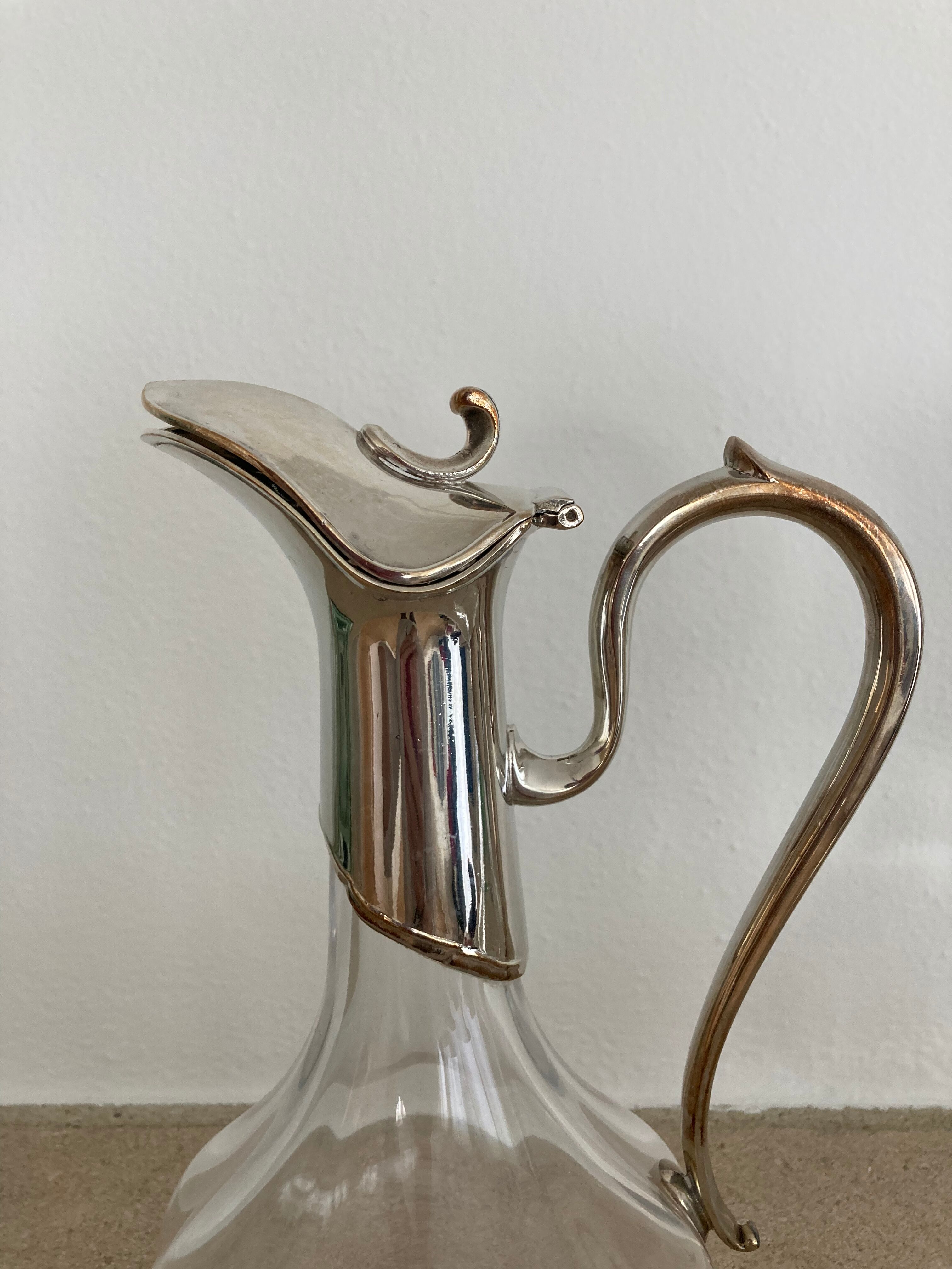 Glass decanters and silver metal spouts