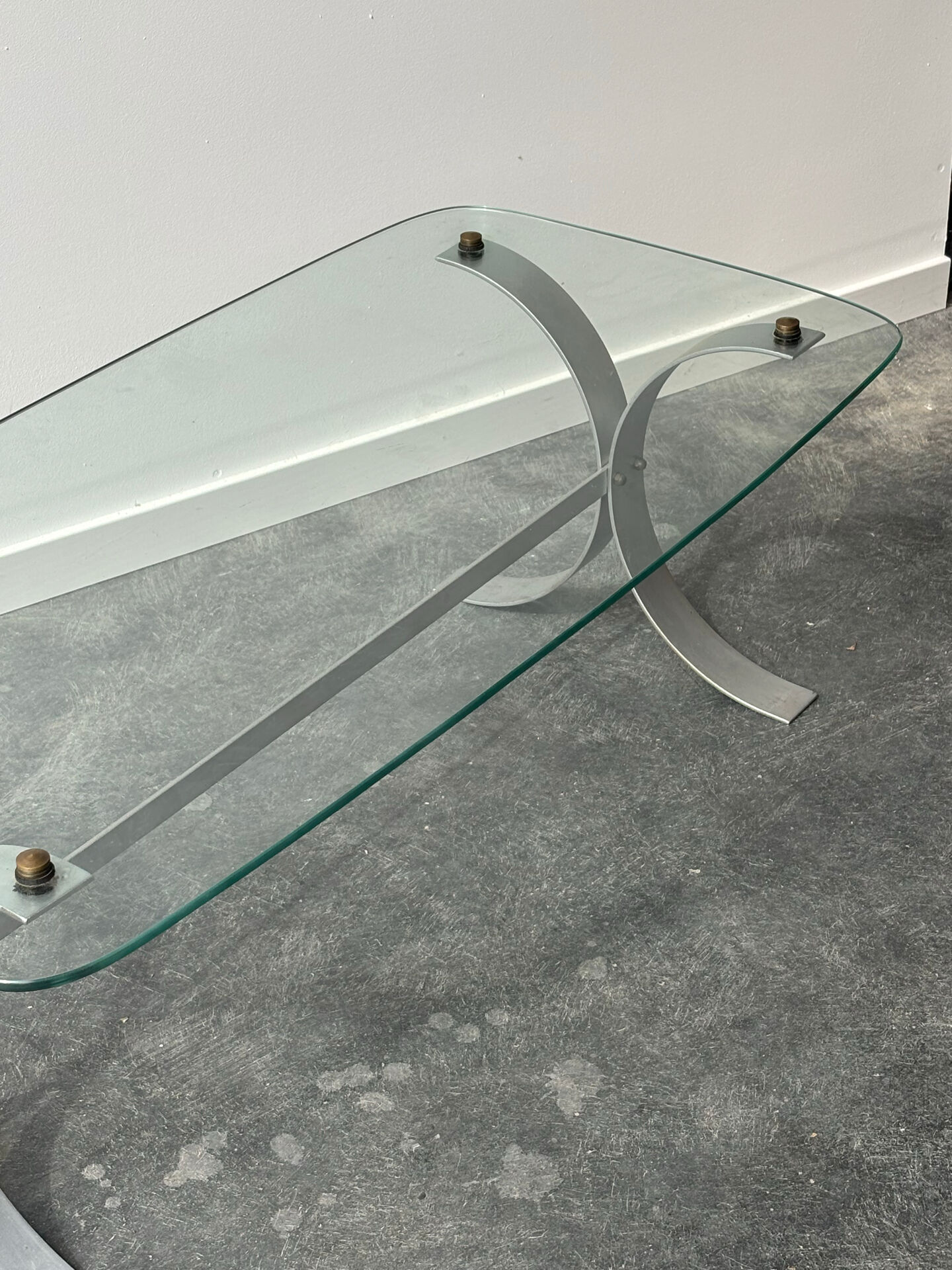 Design coffee table in brushed metal with a glass top, 1970s.