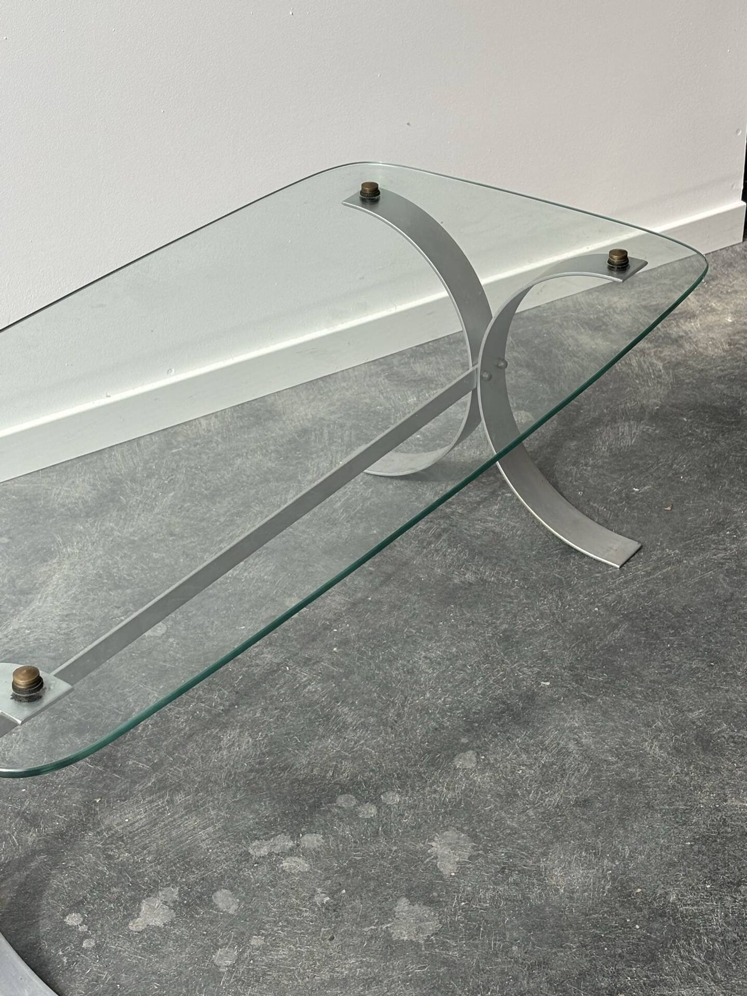 Design coffee table in brushed metal with a glass top, 1970s.