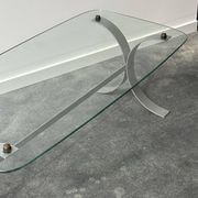 Design coffee table in brushed metal with a glass top, 1970s.