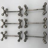 Set of 6 old table knife resistors in the shape of crossbars in silver metal